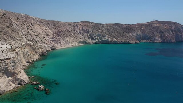 Aerial drone video of beautiful scenic but inaccessible by car steep cliff and beach of Gerakas with crystal clear emerald sea next to famous beach of Tsigrado, Milos island, Cyclades, Greece