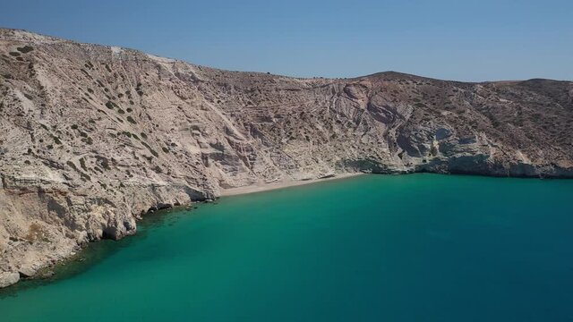 Aerial drone video of beautiful scenic but inaccessible by car steep cliff and beach of Gerakas with crystal clear emerald sea next to famous beach of Tsigrado, Milos island, Cyclades, Greece