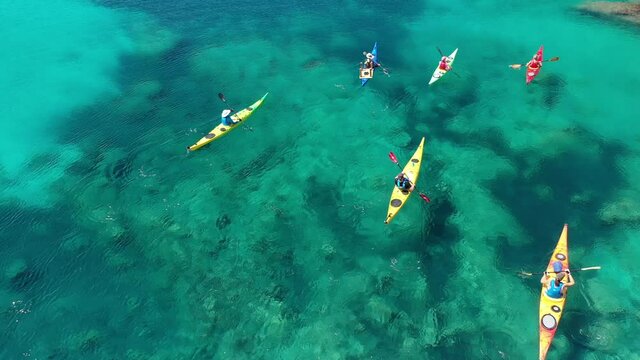 Aerial drone video of women athletes rowing in sports kayak in tropical Caribbean exotic destination with turquoise calm sea