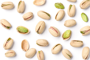 Flat lay of pistachio nuts on a white background.