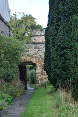 Narrow Path & Garden with Open Doorway in Old Stone Wall 