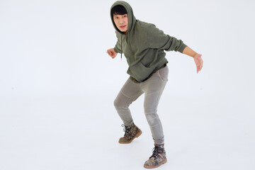 Smiling Asian young professional dancer man is break dancing by one leg and arm isolataed on white background in studio. Education and sport for hobbies concept.
