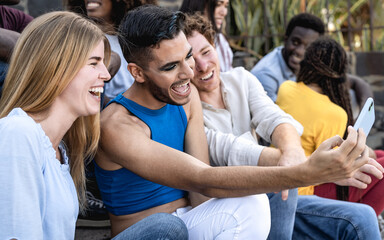 Young multiracial group of friends taking selfie with mobile smartphone sitting on stairs - Youth millennial lifestyle concept