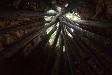Low angle view of the inside of a wood and birch bark traditional native tipi, Gaspé, Quebec, Canada - obrazy, fototapety, plakaty