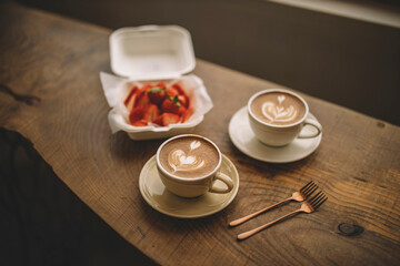 coffee and strawberries / two cups of coffee