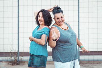 Two adult twin sisters having fun. Positive vibes