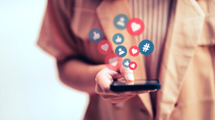 Hands of woman using a social media marketing concept on mobile smartphone with notification icons.