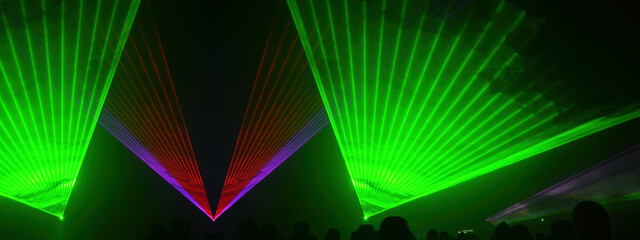 Lasershow festival disco  party background banner panorama - Colorful outdoor laser show with rays...