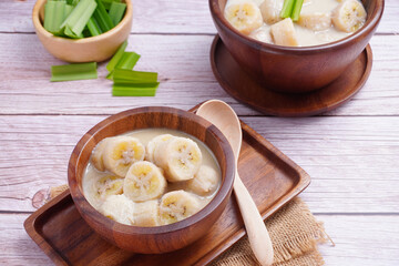 Banana in coconut milk, on a wooden cup of Thai dessert