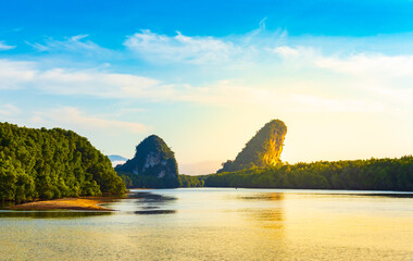 Landscape view of Khao Khanap Nam with golden sunlight shining on water and mangrove forest on day...