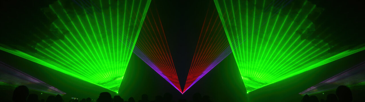 Lasershow festival disco  party background banner panorama - Colorful outdoor laser show with rays streams and crowd silhouette of party people
