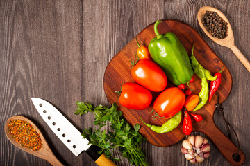 Ingredients for cooking with tomatoes, various peppers, garlic and green peppers.