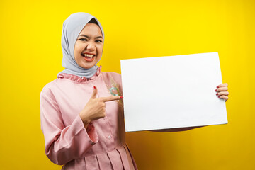 Pretty young muslim woman cheerful holding blank empty banner, placard, white board, blank sign board, white advertisement board, presenting something in copy space, promotion