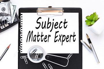 Business Acronym SME as Subject Matter Expert. text on a white sheet of paper near a magnifying glass m flowerpot in a pot