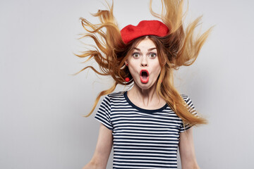Fototapeta premium cheerful woman in a striped t-shirt red lips gesture with his hands summer