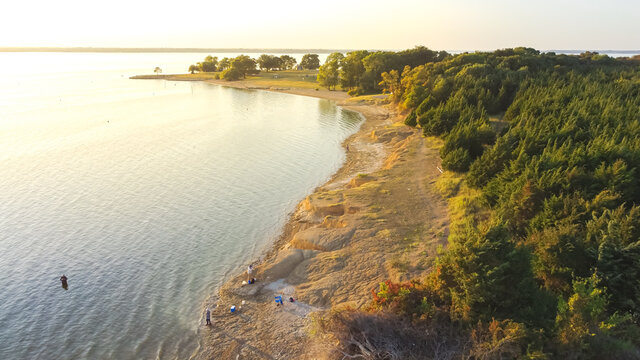 Top view people bank fishing along the sandy shore line at Ticky Creek Park, Lake Lavon, Texas, USA