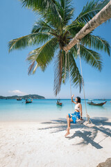 Fototapeta na wymiar woman on the beach, clear water sea with blue sky on the Holiday, palm tree beach, at Haad Chaloklum beach, koh phangan island,suratthani , thailand
