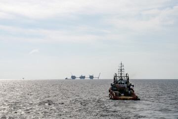 An offshore anchor handling tug boat sailing at offshore oil field