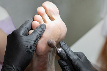 Salon pedicure procedure on the background of a towel.