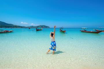 Fototapeta na wymiar woman on the beach, clear water sea with blue sky on the Holiday, palm tree beach, at Haad Chaloklum beach, koh phangan island,suratthani , thailand