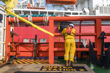 An offshore construction supervisor leaning on the railing while waiting to transfer from a boat to a construction work barge at offshore oil field.