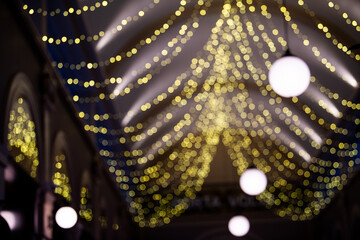 Abstract blurred background with bokeh colorful circles. City lifestyle backdrop made with street lamps and garland lights