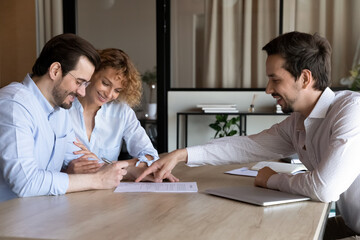 Happy couple of clients signing house buying, rent contract, insurance agreement, filling bank...