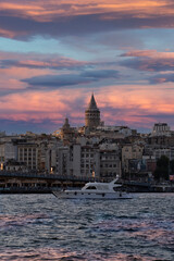 Obraz premium Cityscape of a part of Istanbul city showing homes and Galata tower at sunset at the Harborside Eminönü.