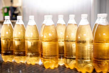 Conveyor belt with bottles for juice or water at a modern beverage plant