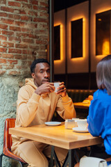 Serious african american man drinking coffee