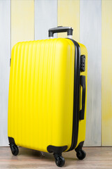 on a gray-yellow background, a travel suitcase, close-up