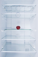 red apple, in the refrigerator, on a glass shelf, on a white background