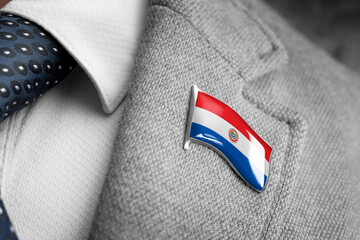 Metal badge with the flag of Paraguay on a suit lapel