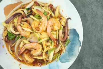 Mango spicy salad with seafood hot and spicy tasty appetizer