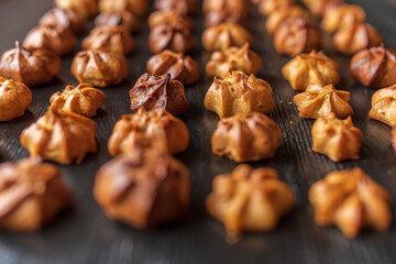 Delicious homemade organic eclairs laid out in a row on a wooden surface.