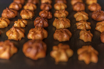 Delicious homemade organic eclairs laid out in a row on a wooden surface.
