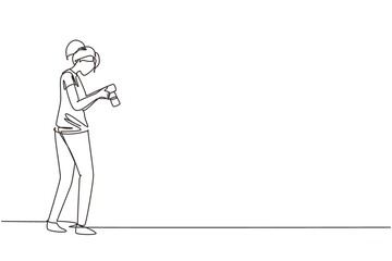 Single one line drawing woman photographers or paparazzi taking photo with digital cameras with angles. Girl Journalists or reporters checking pictures. Continuous line draw design vector illustration
