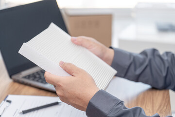 Close up hand a man hold air filter of car cooling system and check the correctness of the spare parts model for maintenance in service center