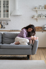 Caring mom embracing offended little kid crying after abuse in family. Worried young woman hugging...