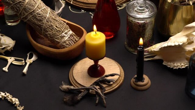 Witchcraft table set, selective focus. Alchemy and esoteric symbol items for magic cult. Spiritual occultism and magic chemistry inspired by mysticism. Witch and warlock magician concept. Halloween.