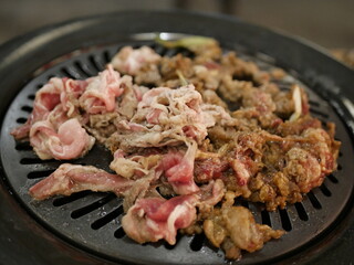 Eating food in a Japanese restaurant, grilling meat and eating it in a bowl and plate