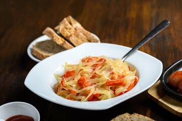 grilled sausage with stewed onions