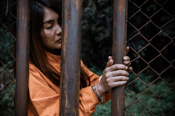 Portrait of women desperate to catch the iron prison,prisoner concept,thailand people,Hope to be...