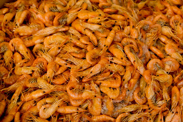 Small fresh boiled pink shrimp ready to eat. Street food festival. Selective focus. Close-up. Food background.