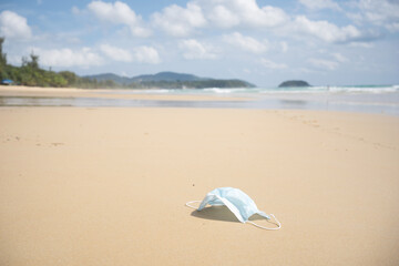Face mask on beach during the corona pandemic.