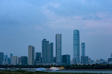 Fototapeta na wymiar Urban skyscrapers under the rosy sky at nightfall;