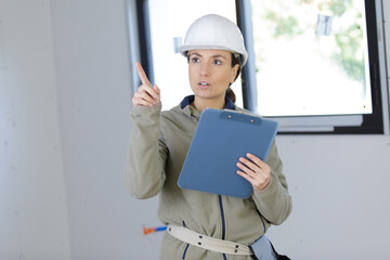 woman builder holding a clipboard