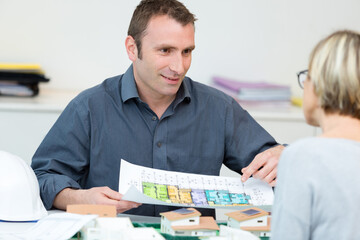 Fototapeta na wymiar real estate agent showing floor plan to client