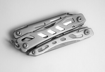 Miniature, pocket-sized universal Multi tool containing a knife, opener, pliers, scissors and  file.