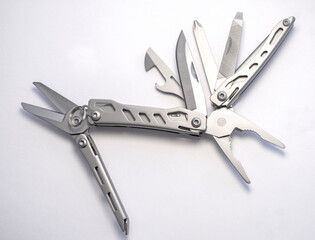 Miniature, pocket-sized universal Multi tool containing a knife, opener, pliers, scissors and  file.